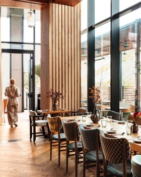 Peacock indoor dining room with server walking by