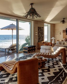 Malibu Beach House living space with two chairs facing beach front terrace