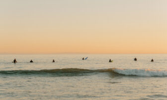 People enjoy surfing ocean waves, relishing the exhilarating thrill of the sea.